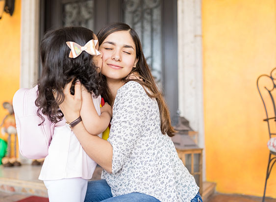 Nanny hugging schoolgirl