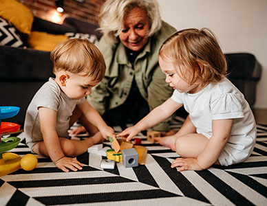 Older caregiver playing with kids