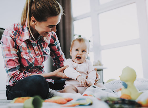 Expert trained childcare specialist playing on the floor with child