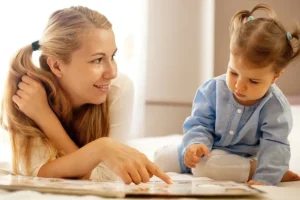 Woman and child reading a book together.