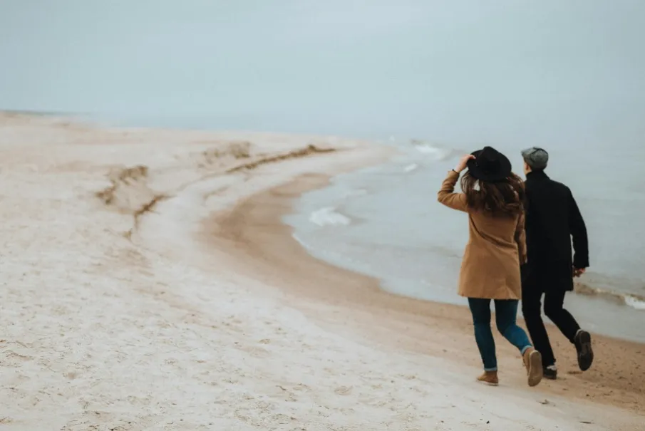 Couple walking along a serene beach