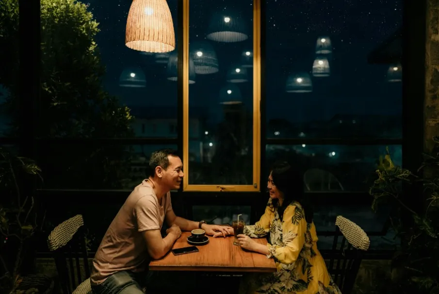 a couple enjoys a drink and conversation.