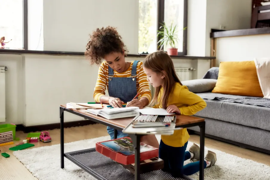Mother helping daughter with homework at home