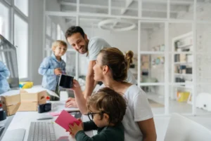 Happy family working together at home office with children