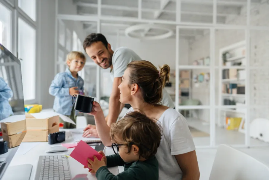 Happy family working together at home office with children