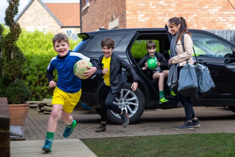 Family arriving home from soccer practice