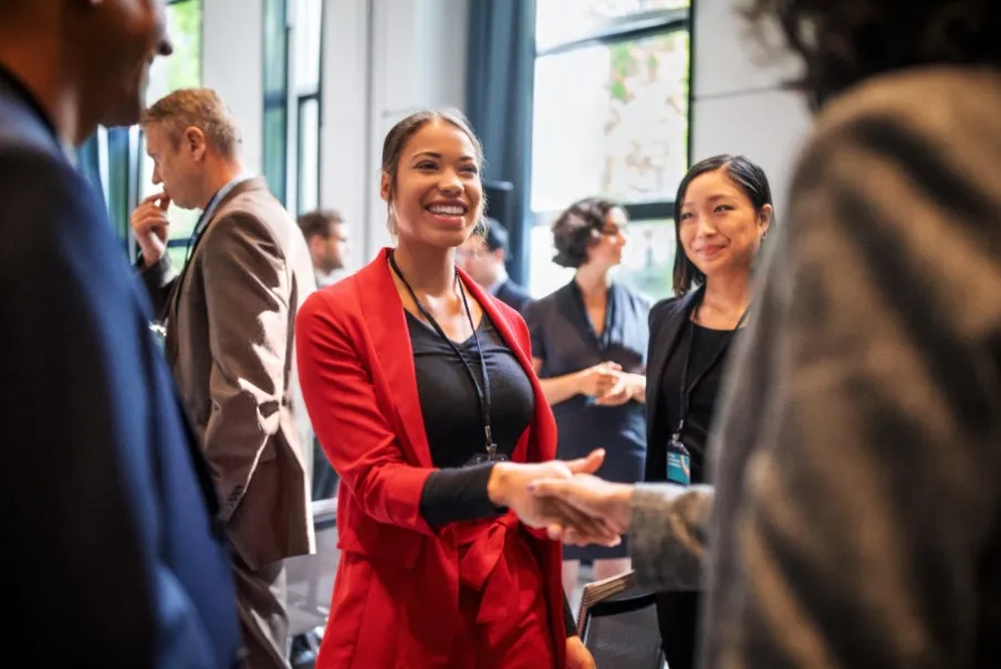 Business professionals networking and shaking hands at a conference