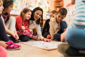 Teacher interacting with children during an educational activity in the classroom.