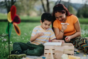 Mother and son enjoying a creative outdoor picnic in a park