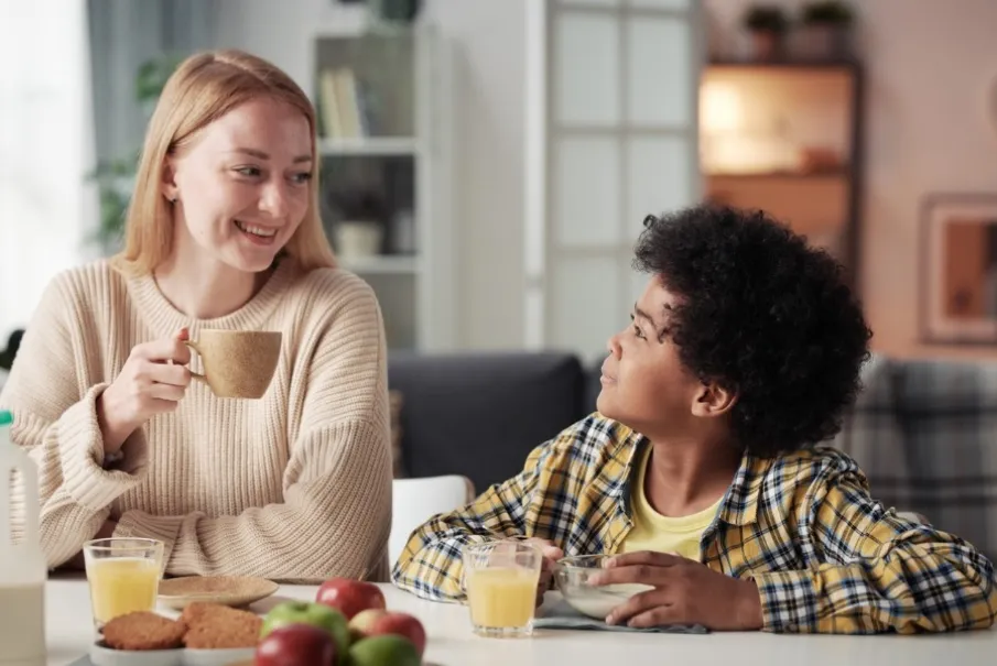 Parent and child enjoying breakfast together at home