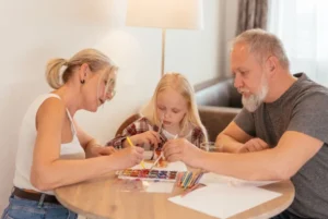 Family enjoying watercolor painting session at home.
