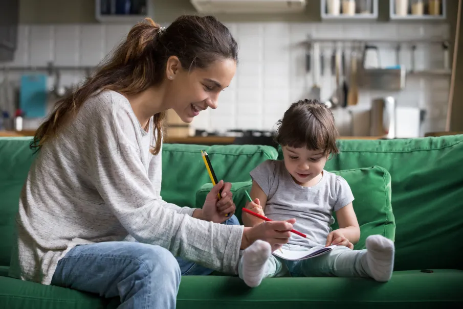 Mother and daughter drawing together at home